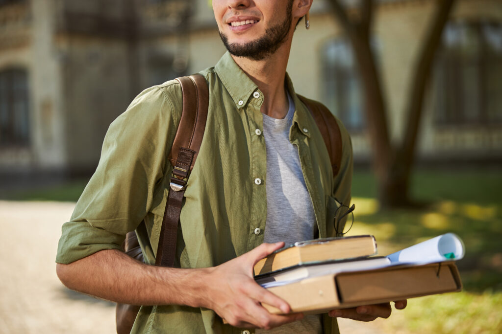 Student holding academic literature