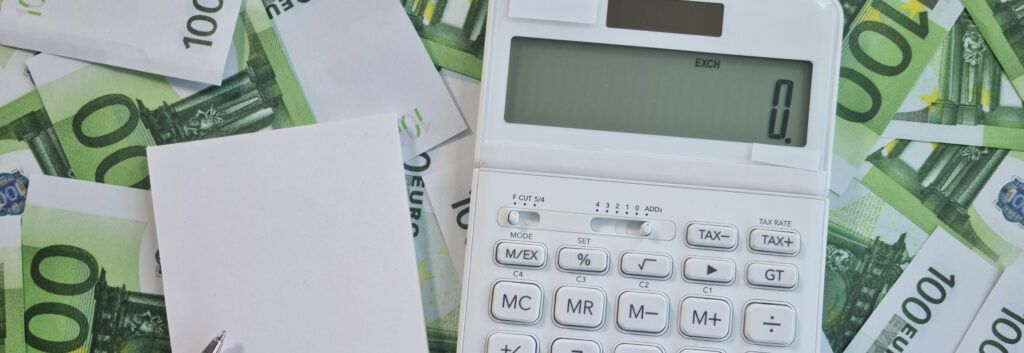 Calculator and money representing publishing costs