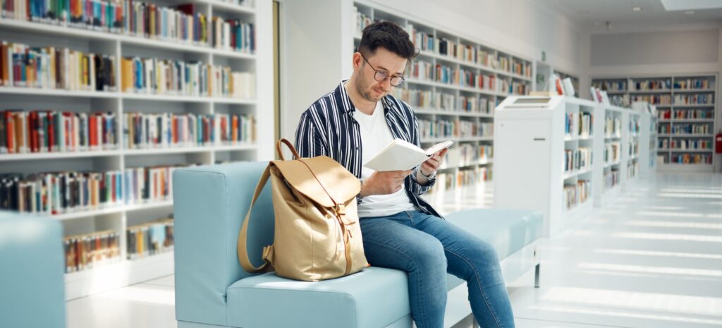 Person reading a book in a library