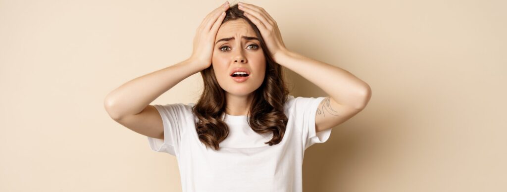 An anxious author holding her head
